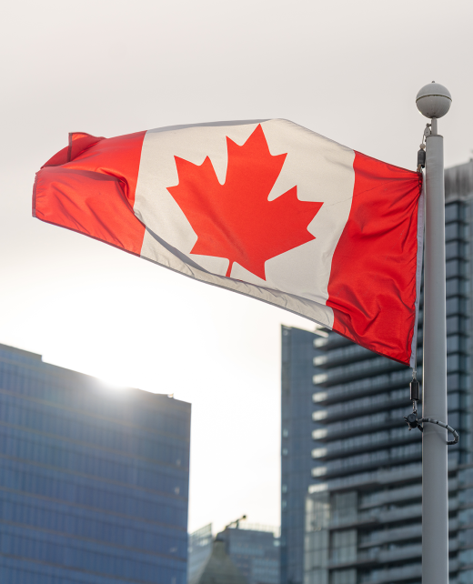 close-up-national-flag-canada-vancouver-city-skyscrapers-skyline-background-with-sunlight